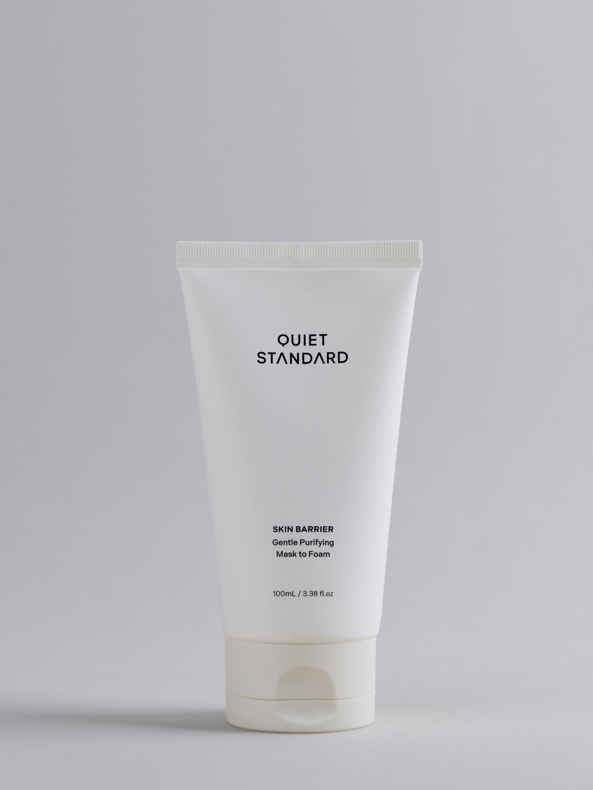 A 100mL white squeeze tube of Quiet Standard Skin Barrier Gentle Purifying Mask to Foam, centered on a light gray background.