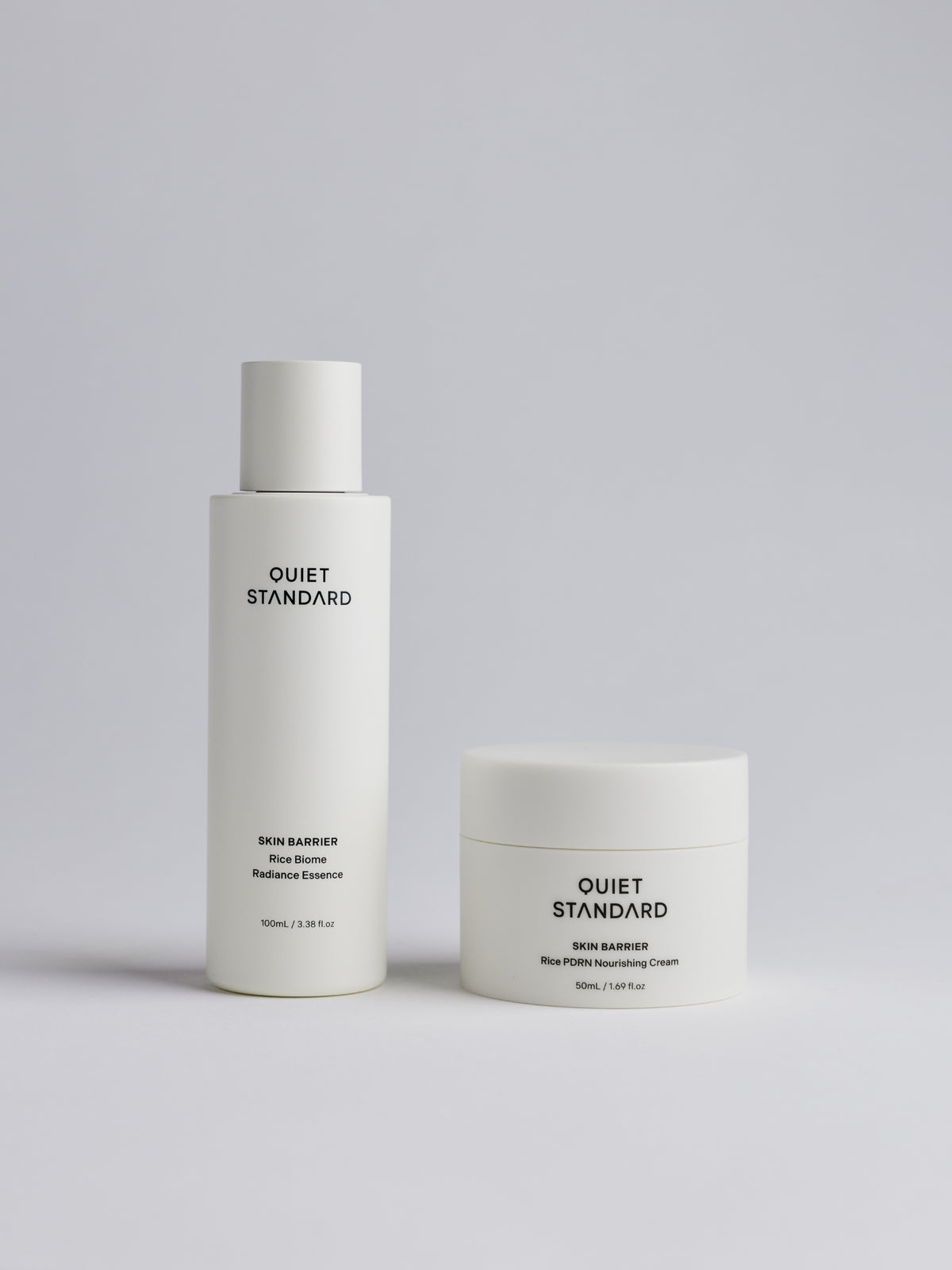 A skincare set from Quiet Standard, featuring Rice Biome Radiance Essence and Rice PDRN Nourishing Cream, set against a clean light gray background.
